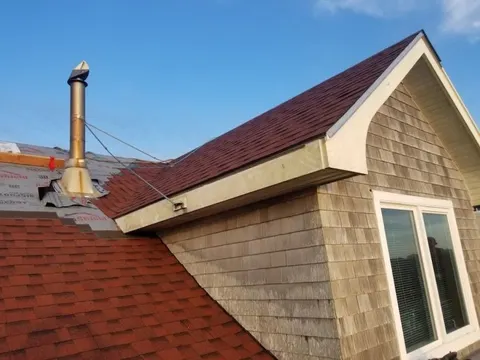 Red asphalt shingle roof completed by Rain or Shine Roofing