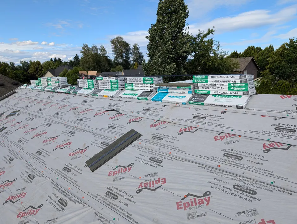 Malarkey Highlander AR shingle bundles staged on synthetic underlayment