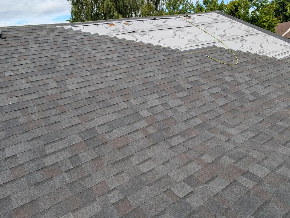 Mid-install photograph of a residential re-roof by Rain or Shine Roofing