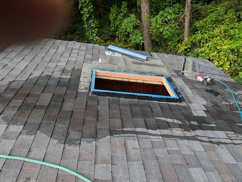 Skylight cutout with blue flashing during a tear-off and replacement