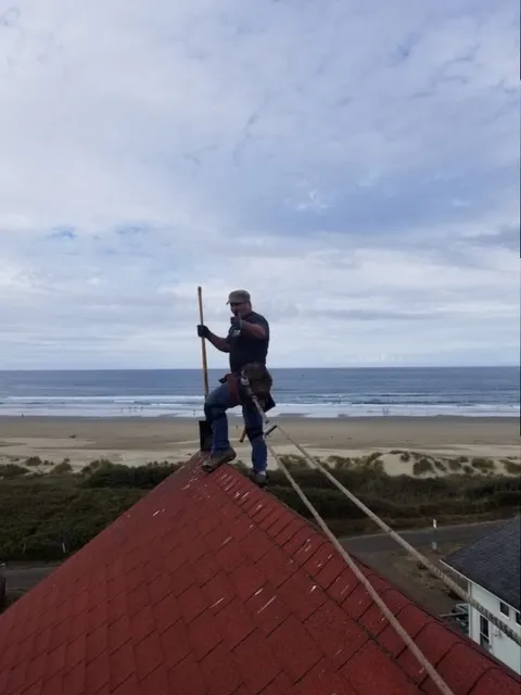 Tim, owner and lead roofer at Rain or Shine Roofing, on a roof in Oregon